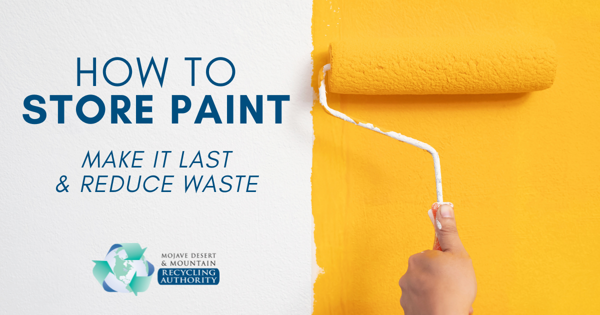 A hand rolls yellow paint on a wall.
