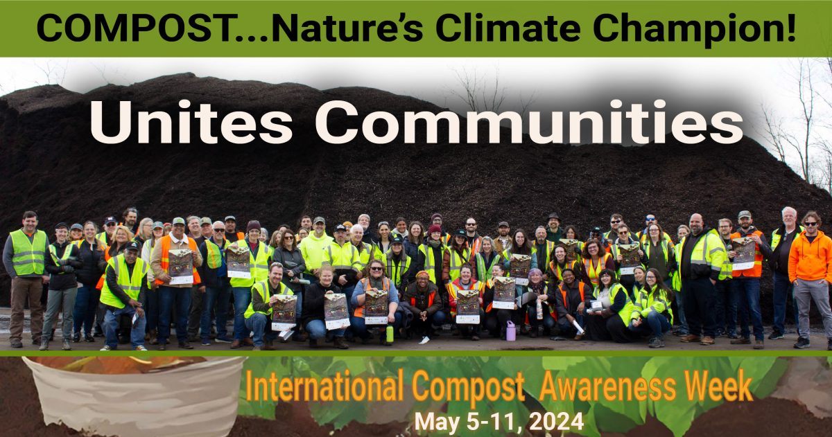 Workers in protective yellow stand in front of a compost pile