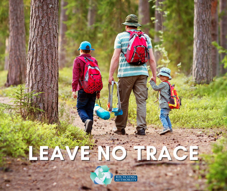 A dad hikes with two young kids