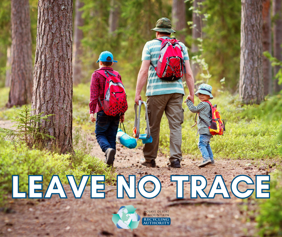 Man walks on forrest path with two kids. Words: Leave no Trace